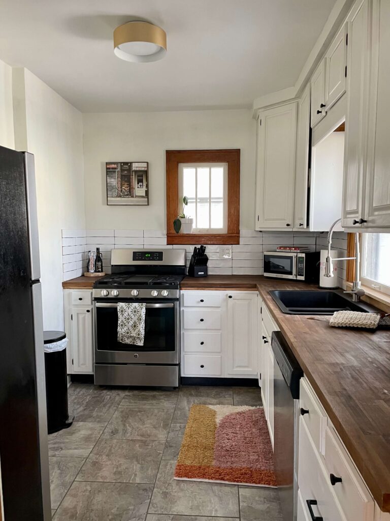 Kitchen with Butcher Block and a DIY Backsplash done with mussel bound tile mat.