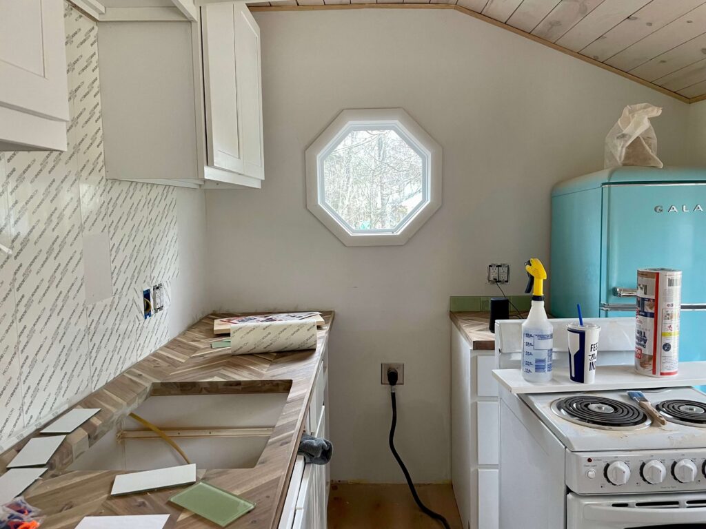 Installing a backsplash with mussel bound tile adhesive mat.