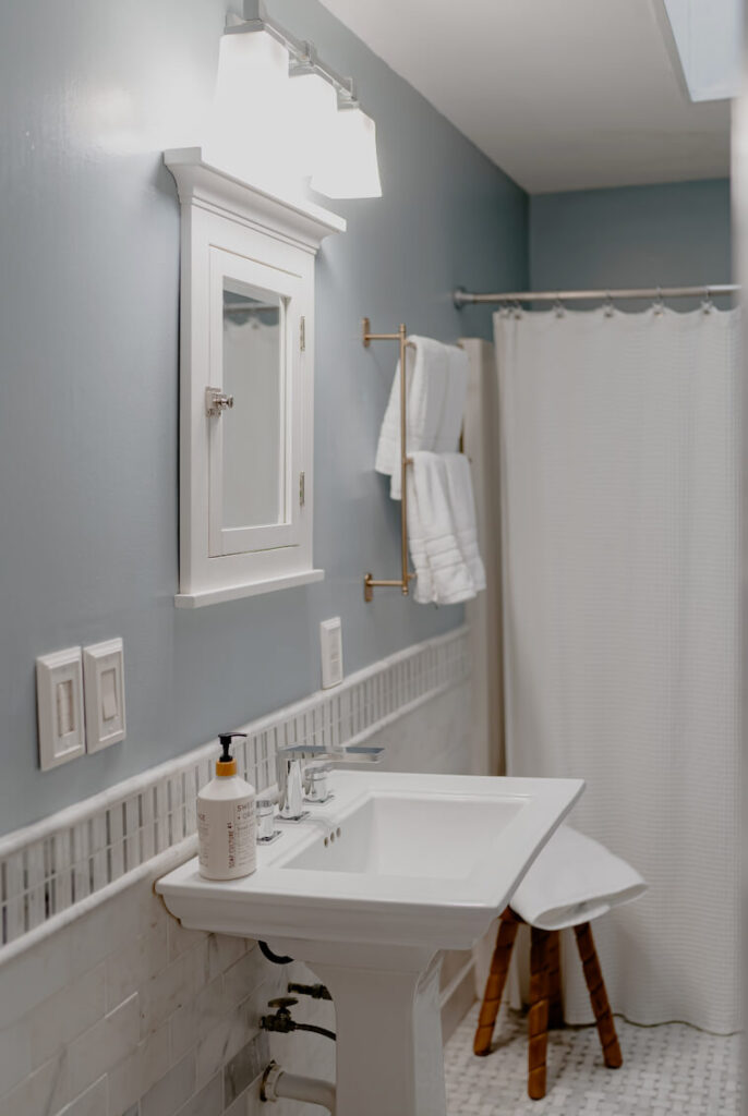 Soft Blue bathroom with white marble tile.