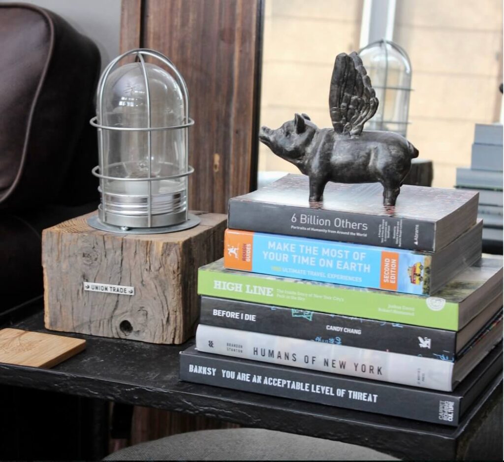Side table with decor and coffee table books at and Airbnb.