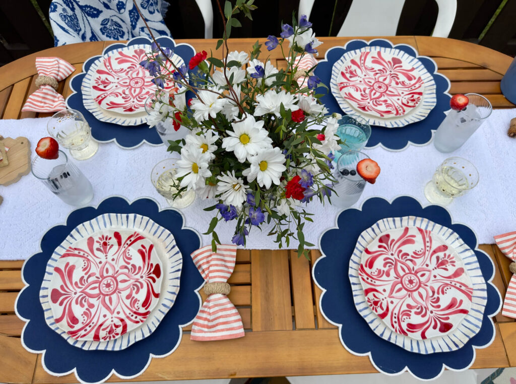 Red, White and Blue Tablescape with floral centerpiece in a watermelon vase. Perfect for summer entertaining.,