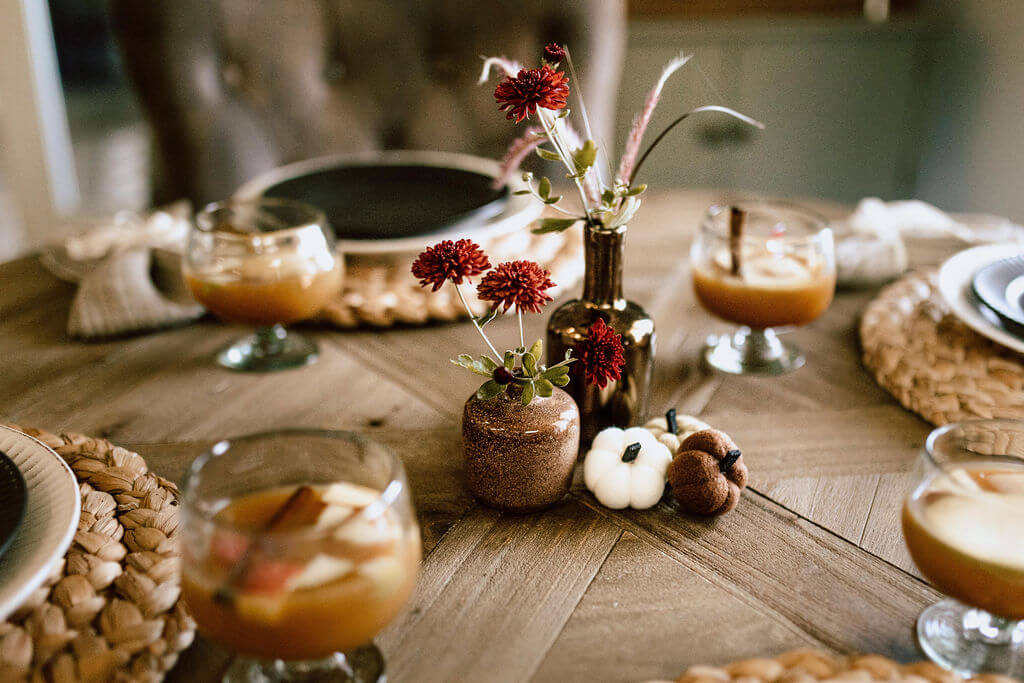 Fall table with flowers from the yard, a cider based cocktail.