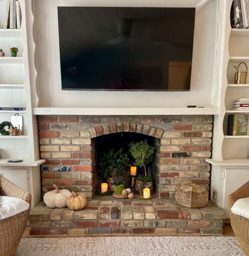 Fireplace decorated for Fall in a cottage located in Pentwater, MI. The Little Green Cottage
