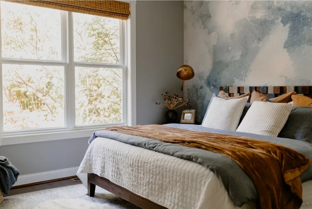 Bed decorated in white quilt with blue duvet and brown throw. Fall Decorating.