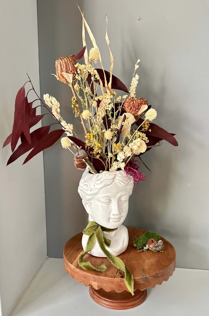 Dried Flower Arrangement in a Lady Head Vase. 