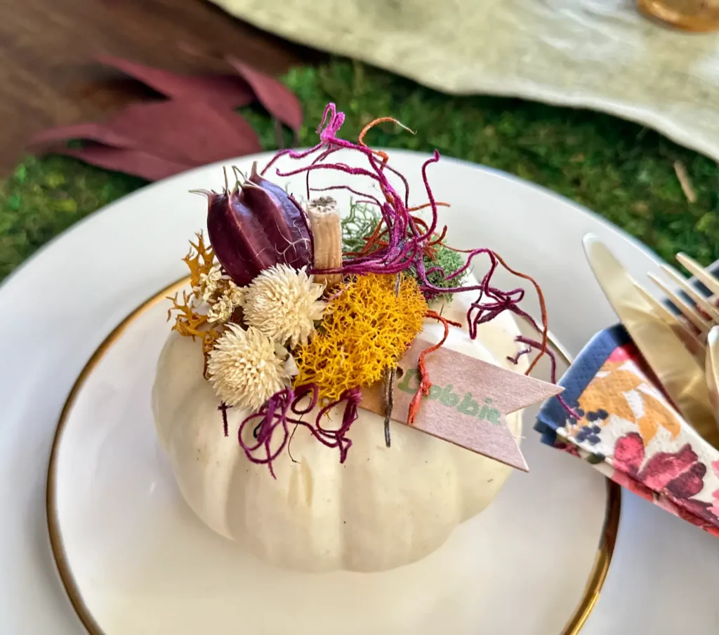 Mini Pumkin with Dried Flowers as a place card for a Thanksgiving celebration.