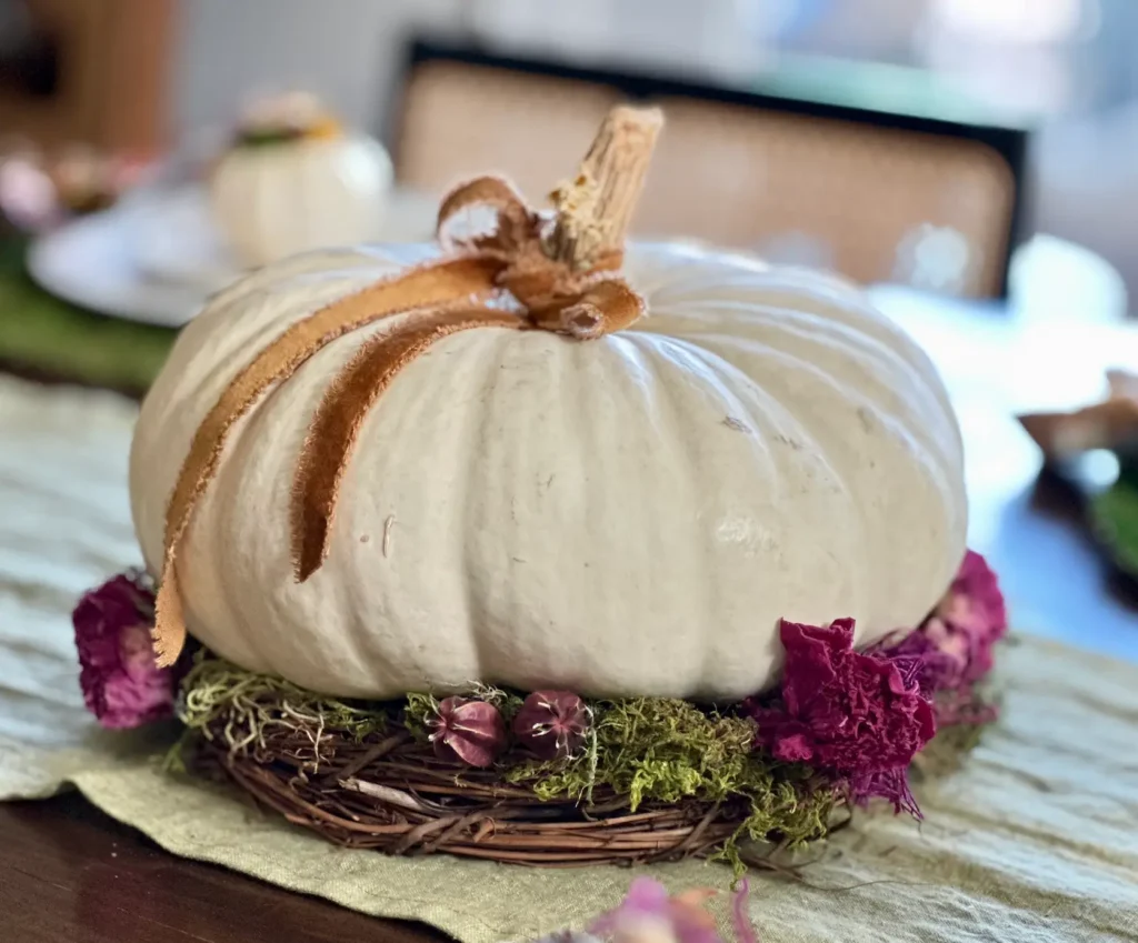White pumkin with grapevine and dried flowers for a Fall Centerpiece.