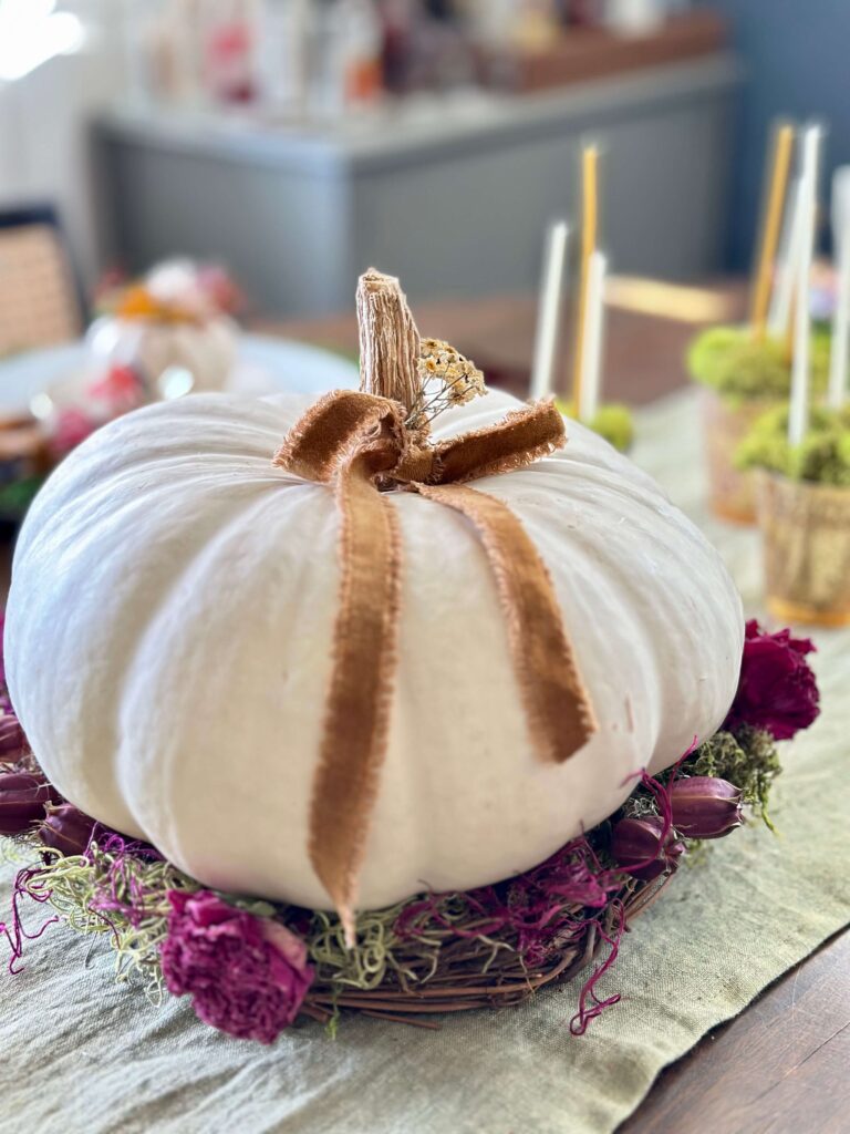 White pumpkin Centerpiece with Dried flowers, Moss, grapevine and a loopy ribbon.