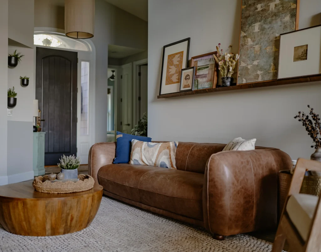 Brown Leather Sofa in Living Space with Art Ledge above.