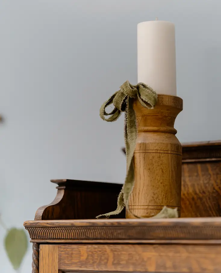 Wooden Candlestick with Candle and Green Velvet Bow.
