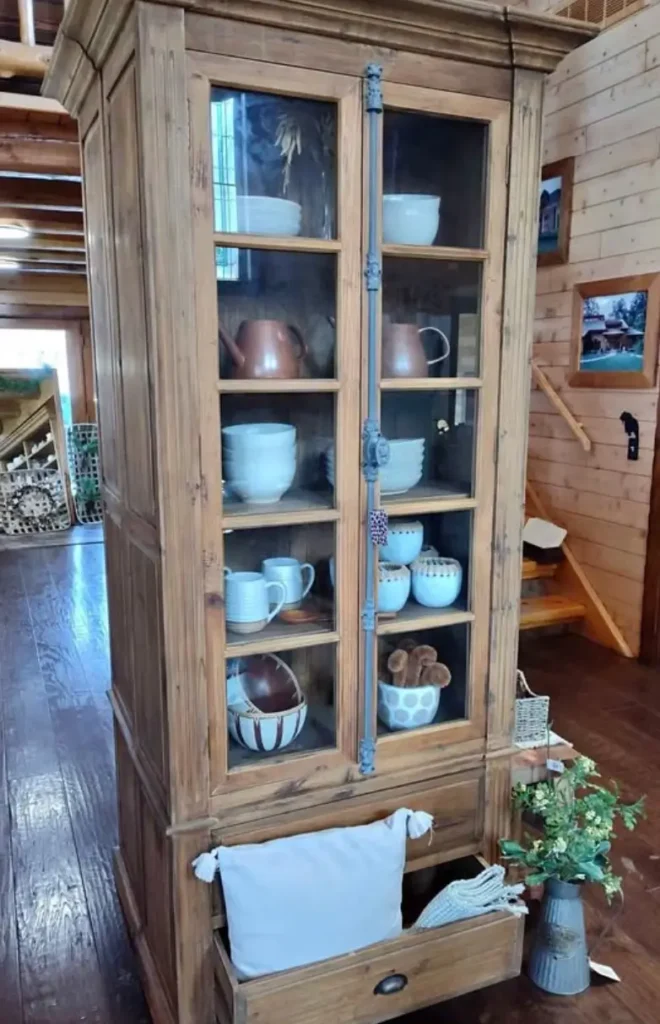 Wood pantry cabinet added to the end of white kitchen cabinets to add warmth to a galley kitchen