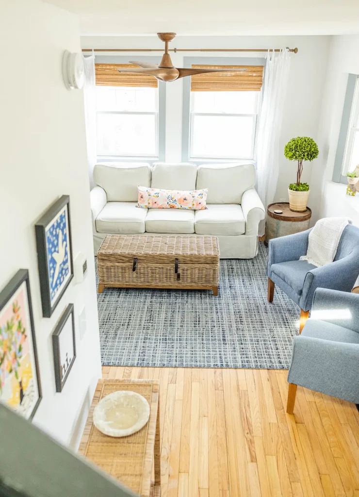 Cottage in Ludington, MI. Photo features picture of Living room with white slipcovered sofa and wicker coffee table.