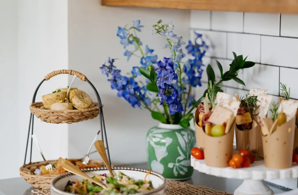 Mother's Day Brunch featuring a green vase of delphiniums.