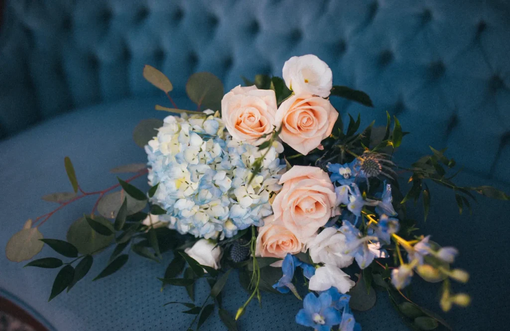 DIY bridal bouguet with delphinium, hydrangea, and garden roses.